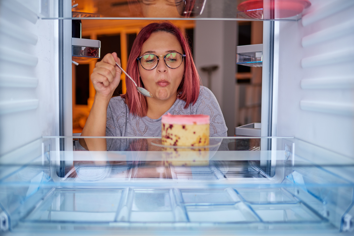 Mulher comendo dentro do congelador