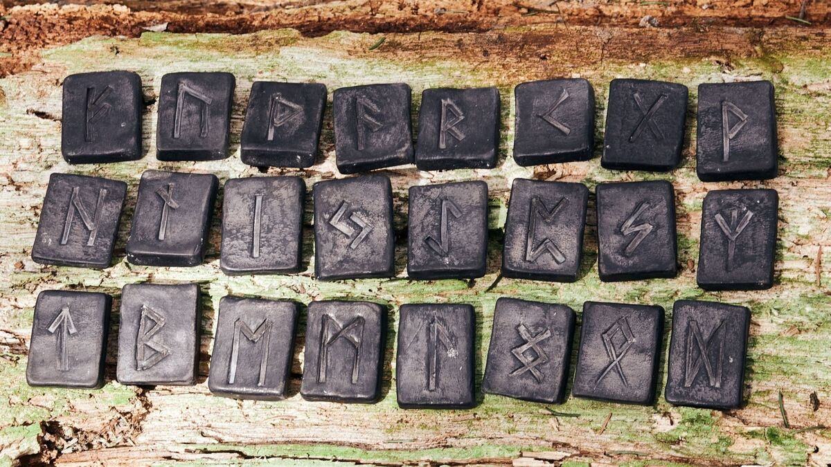 Várias runas em um fundo de madeira.