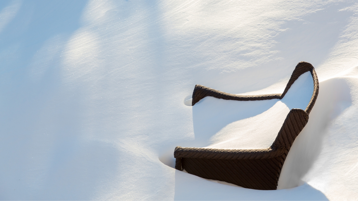 Cadeira enterrada na neve.
