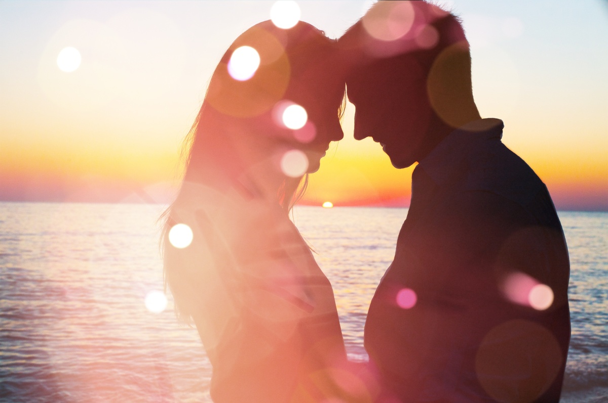 Pessoas do segundo decanato de Capricórnio são românticas. Imagem mostra casal se beijando numa praia.