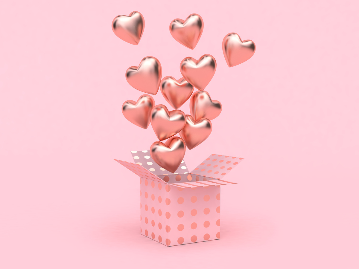Caixa rosa com corações saindo de dentro