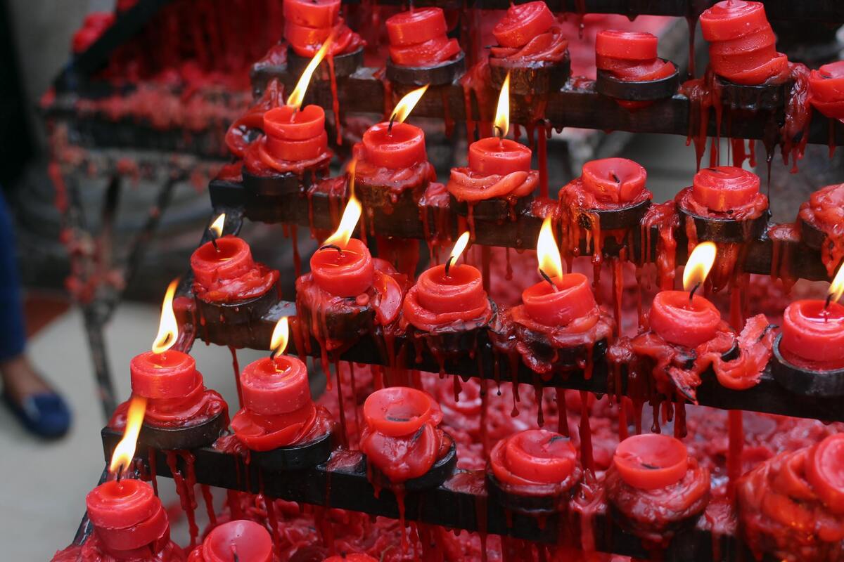 Diversas velas vermelhas acesas. 