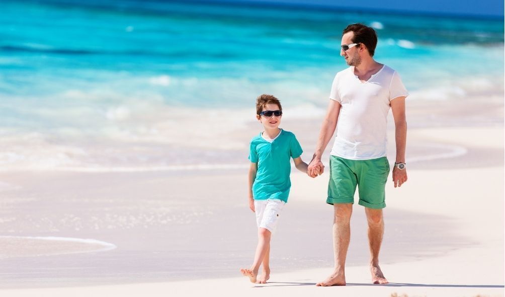Pai andando com filho na praia