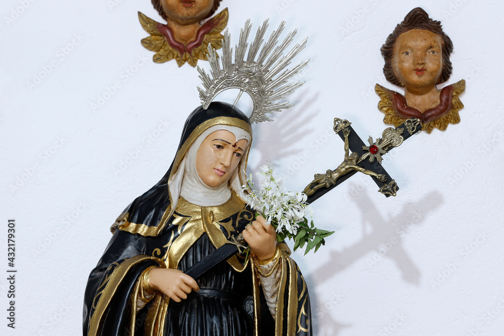 Imagem de Santa Rita de Cássia segurando uma cruz