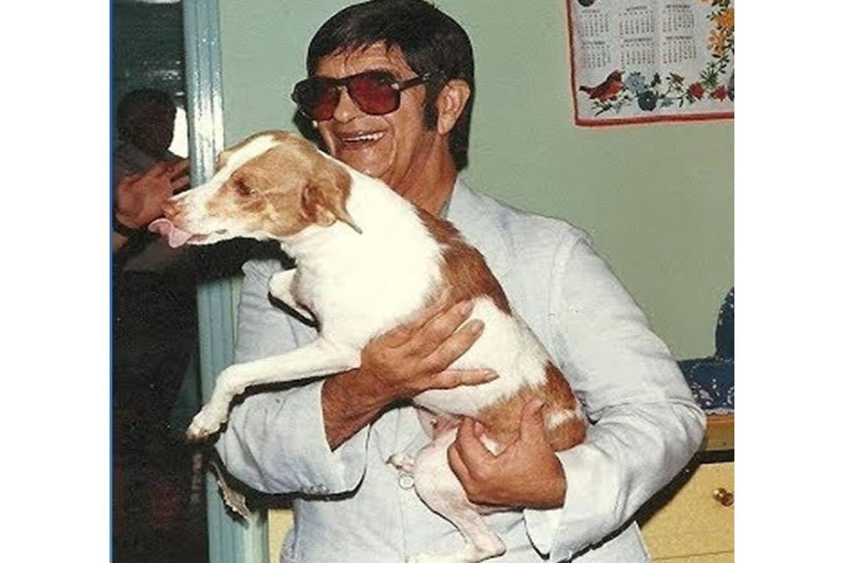 Médium Chico Xavier sorrindo, com um cachorro em seu colo