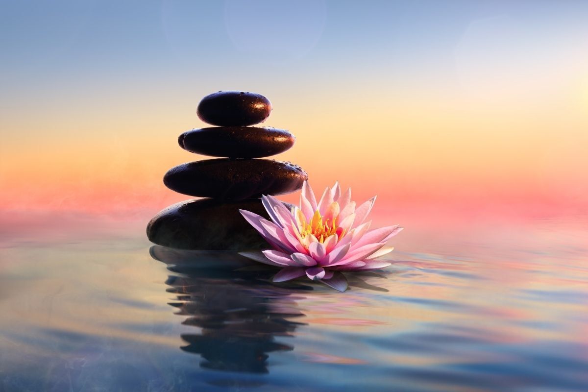 Conceito Zen - Pedras de spa na água ao pôr do sol