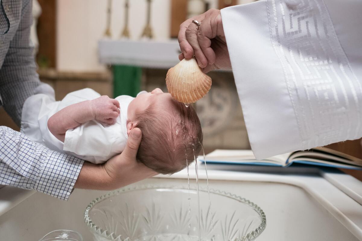 Criança sendo batizada.