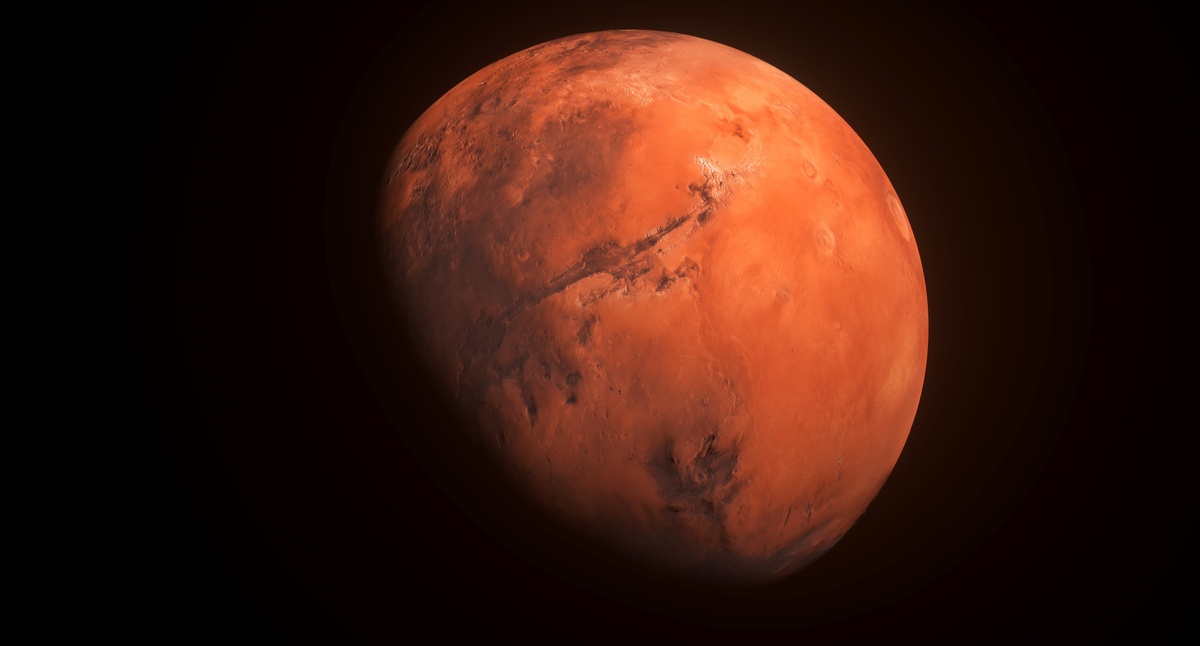 Imagem do planeta Marte visto no espaço enquanto envolto em uma sombra, representando a influência do mesmo quando posicionado em Escorpião dentro de um mapa astral.
