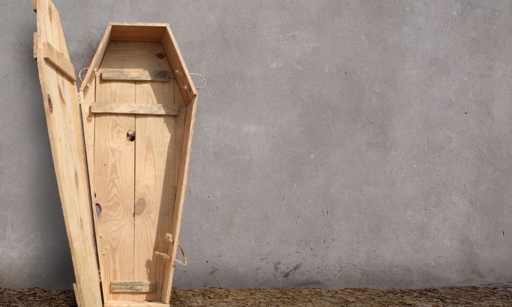 Imagem de um caixão de madeira aberto.