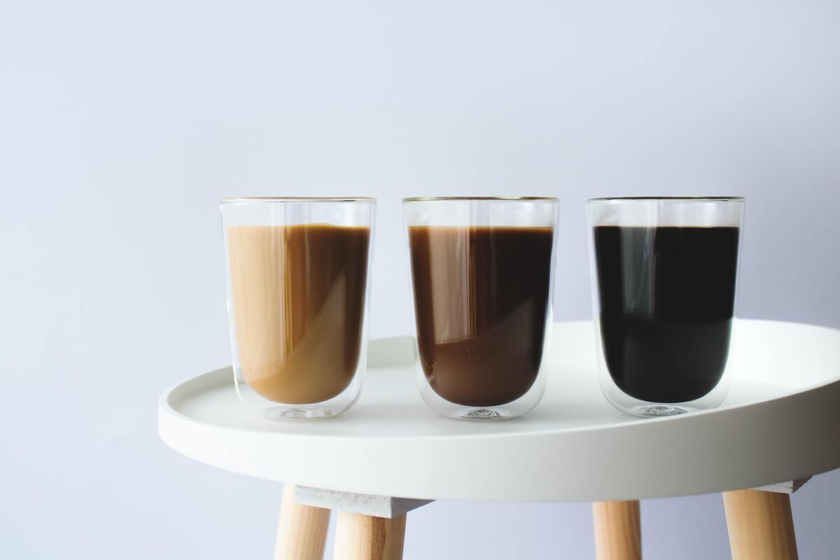Três copos de café de diferentes tonalidades.
