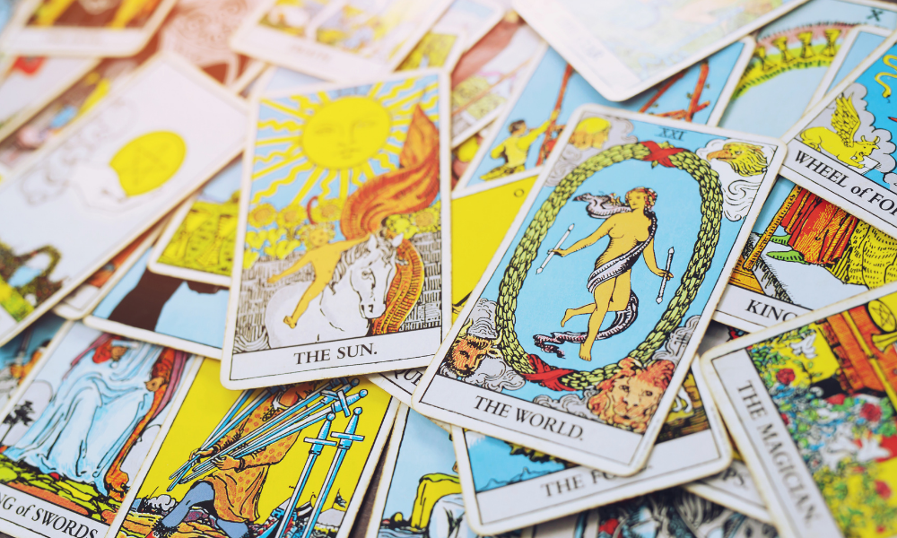 Cartas de tarot com foco nas cartas "The world" e "The sun"